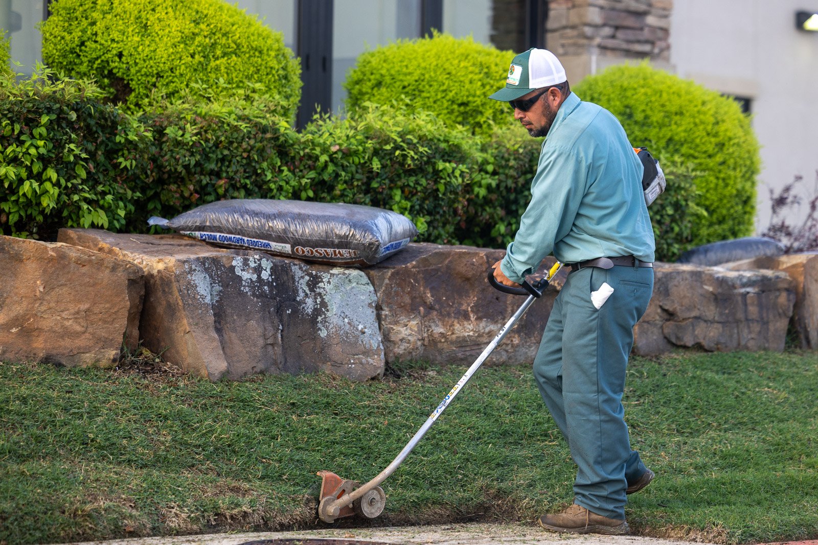commercial landscape maintenance crew trimming pruning hedges bushes 4