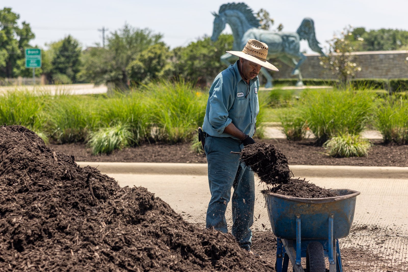 crew shoveling mulch -1