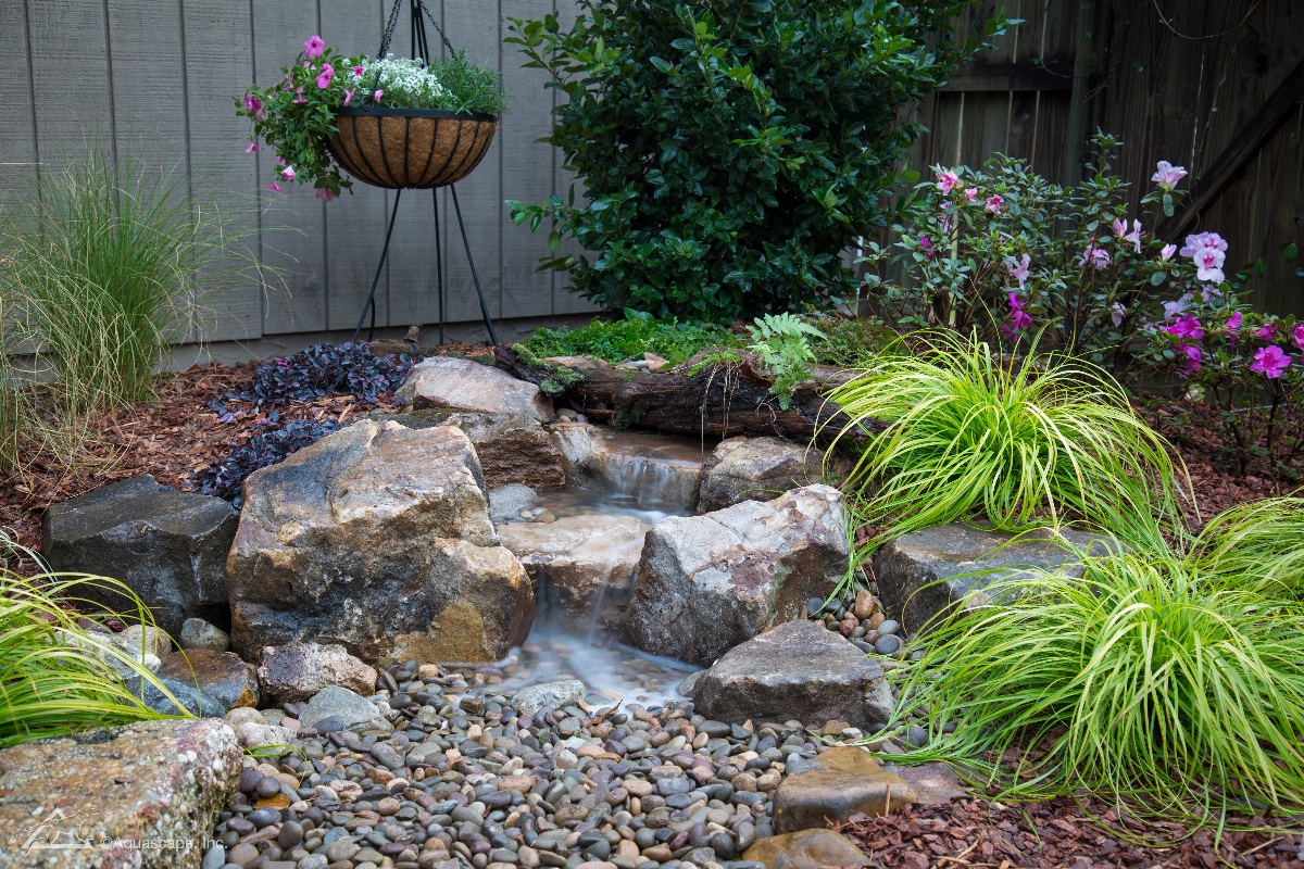 Backyard Waterfall with boulders and plantings
