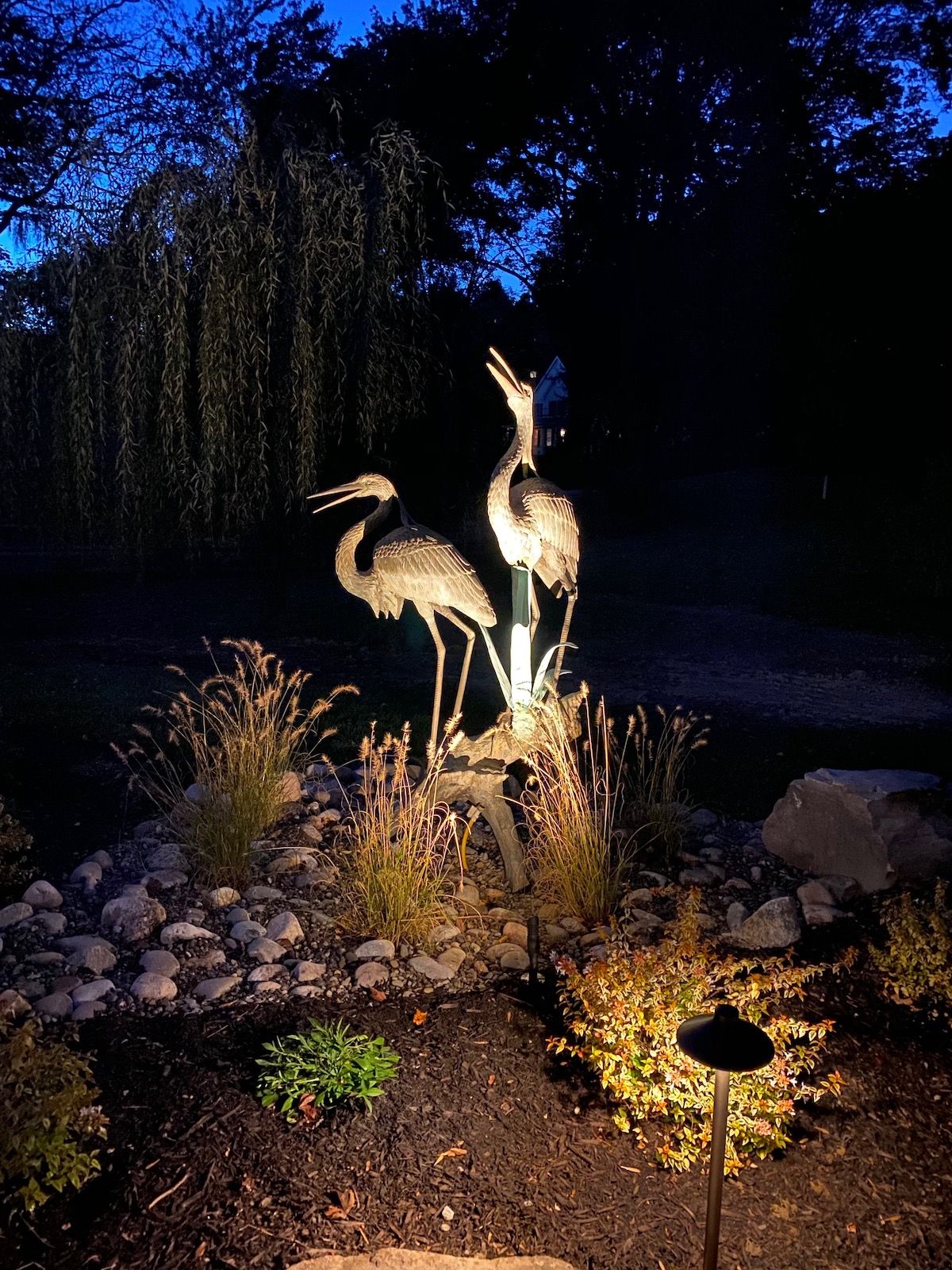 landscape lighting around bird statue
