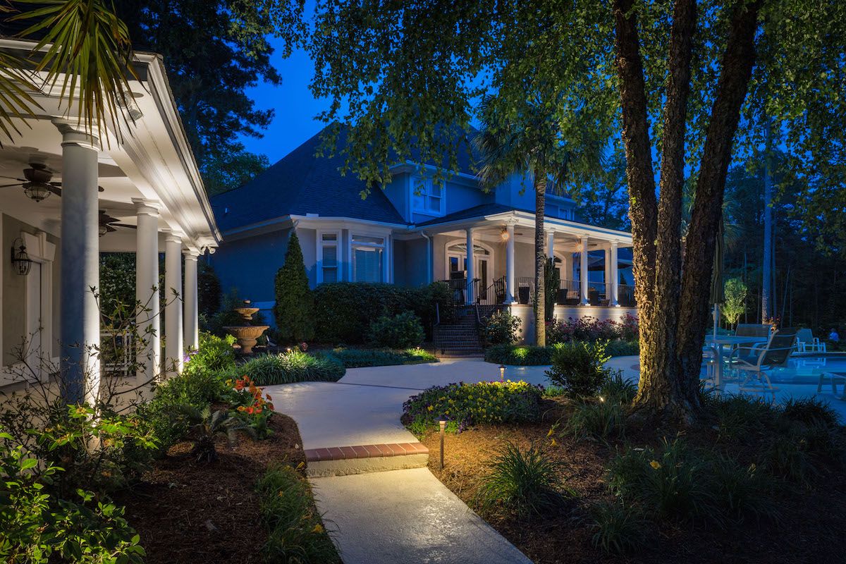 landscape lighting near walkway with patio and pool