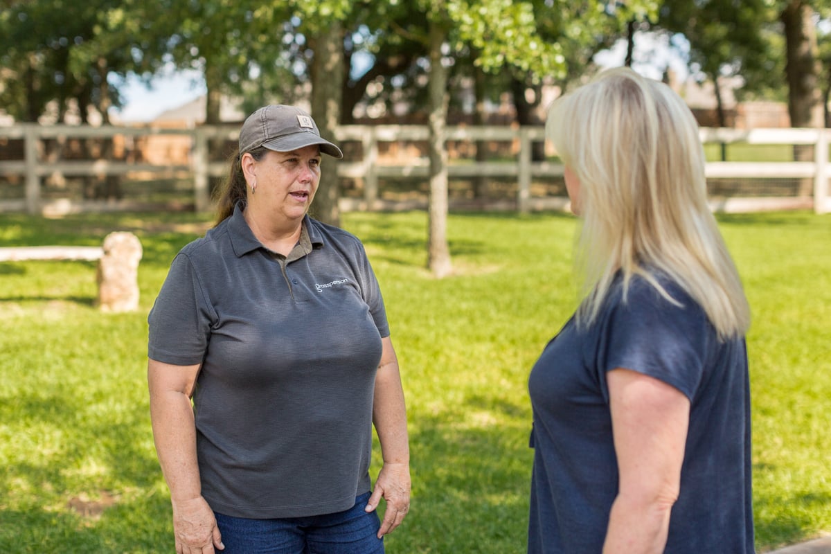 customer talks to landscape professional 