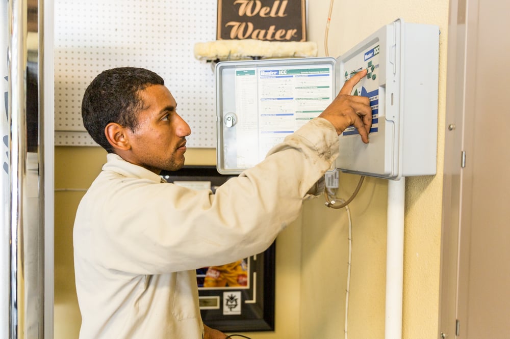 irrigation technician adjusting controls