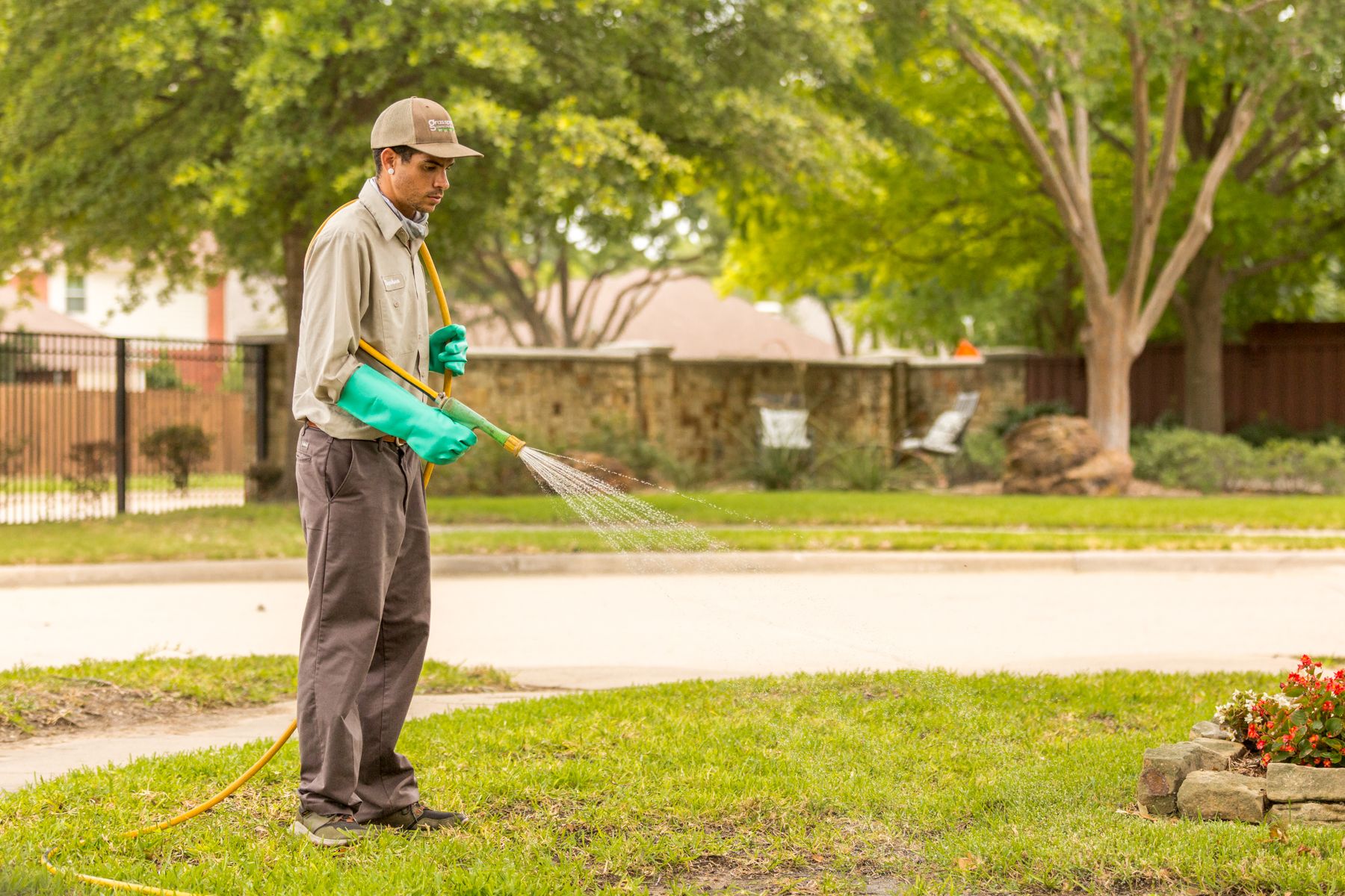 lawn care technician spraying weed control