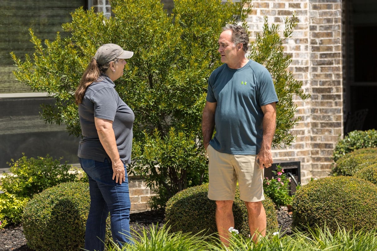 homeowner and account manager talk in front of home