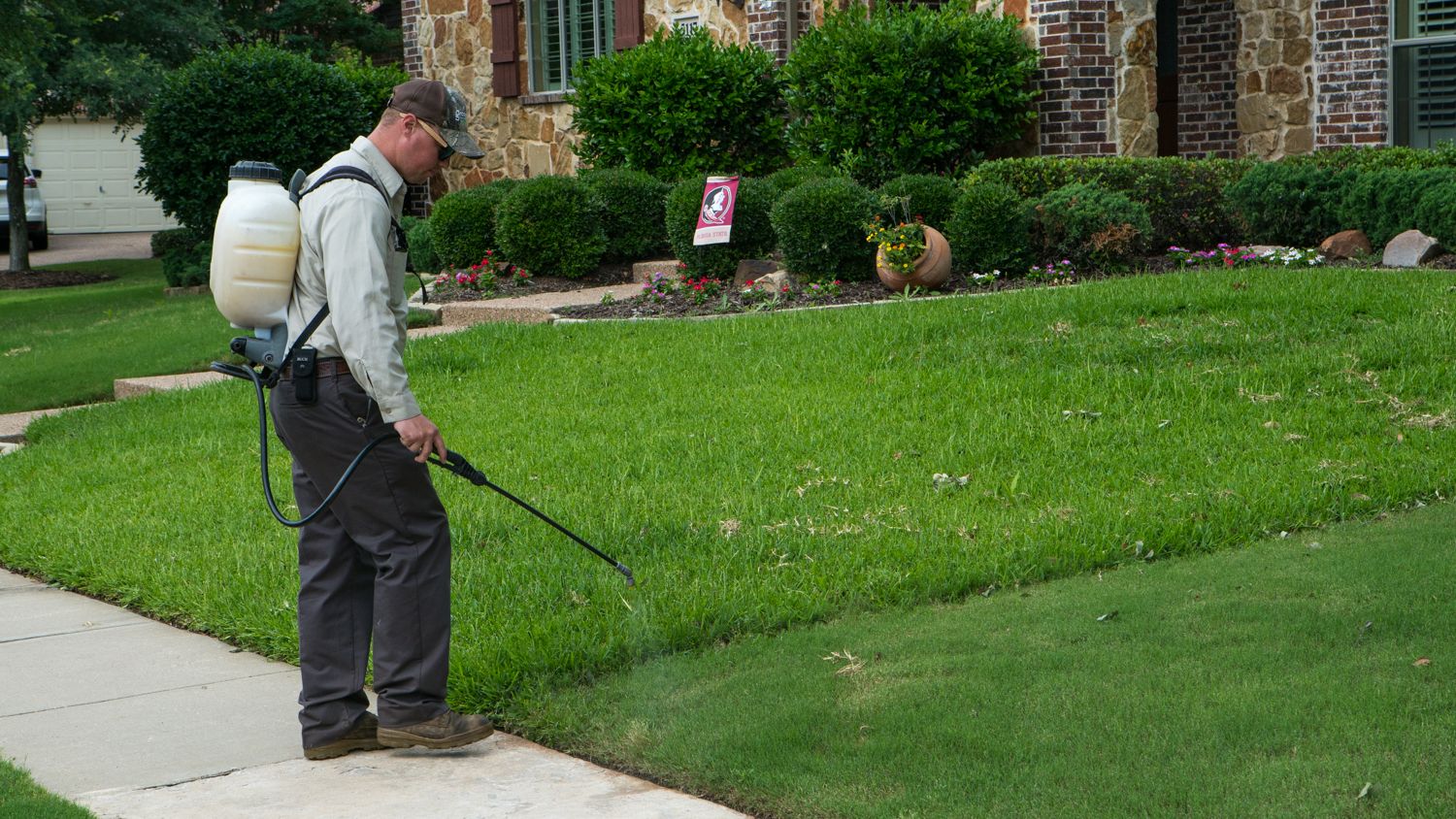 lawn technician spraying lawn in Flower Mound, TX