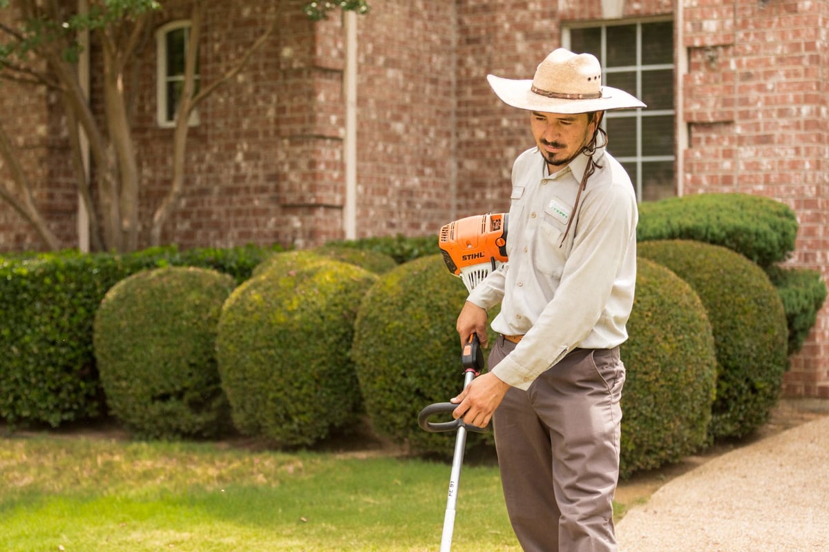 lawn care team edging grass 