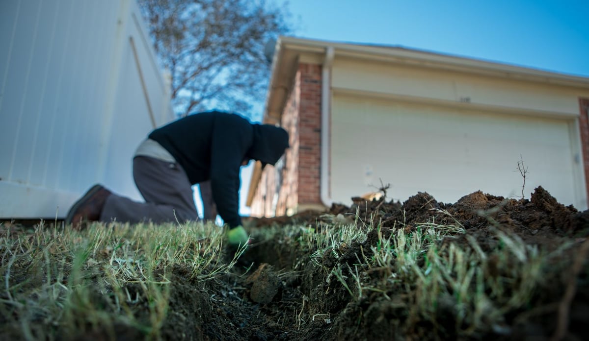 landscape crew installing drainage into yard
