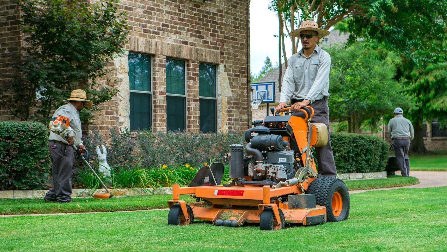 landscape field workers maintaining lawn in Texas