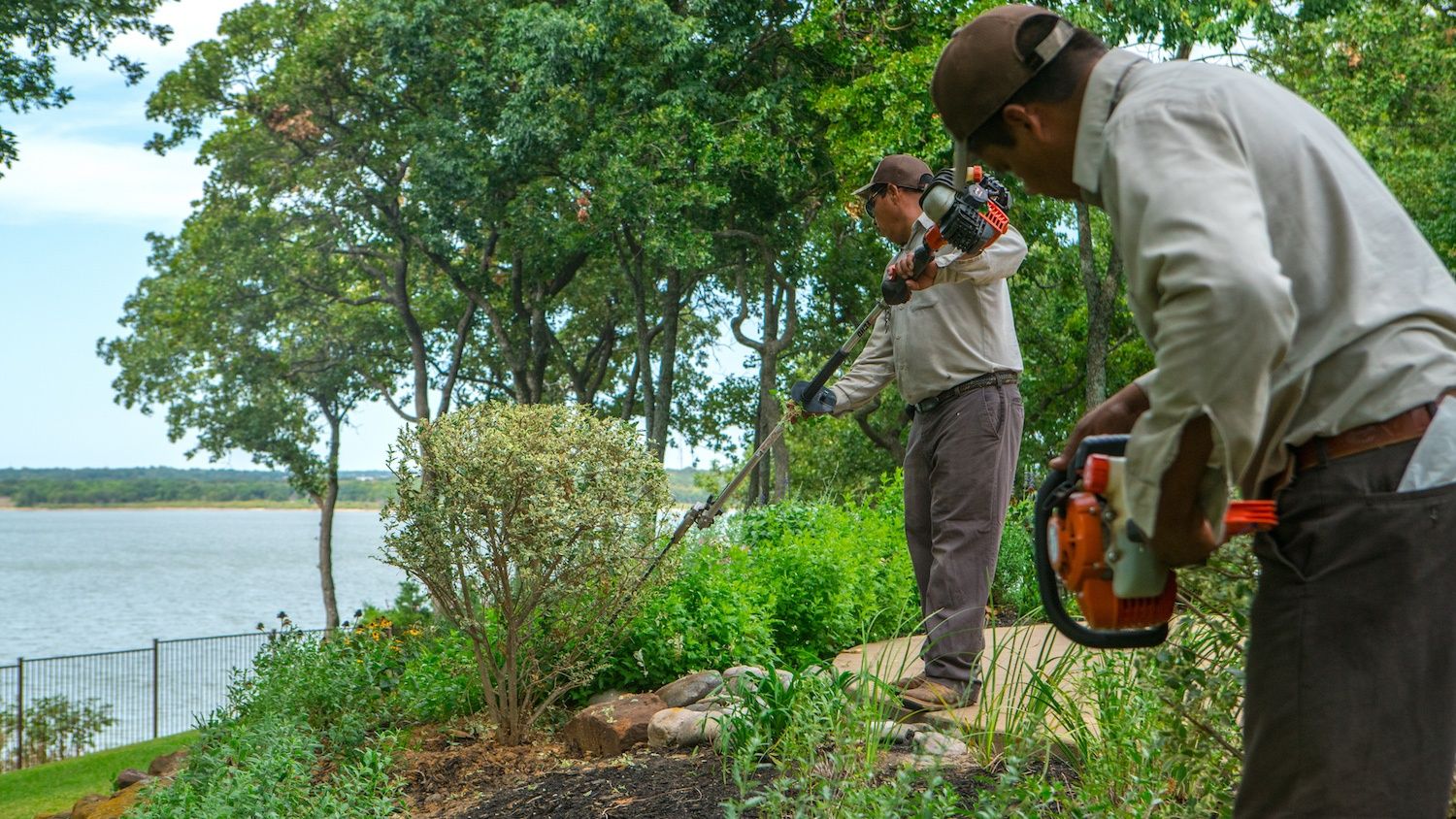 landscape maintenance company crew trimming shrubs