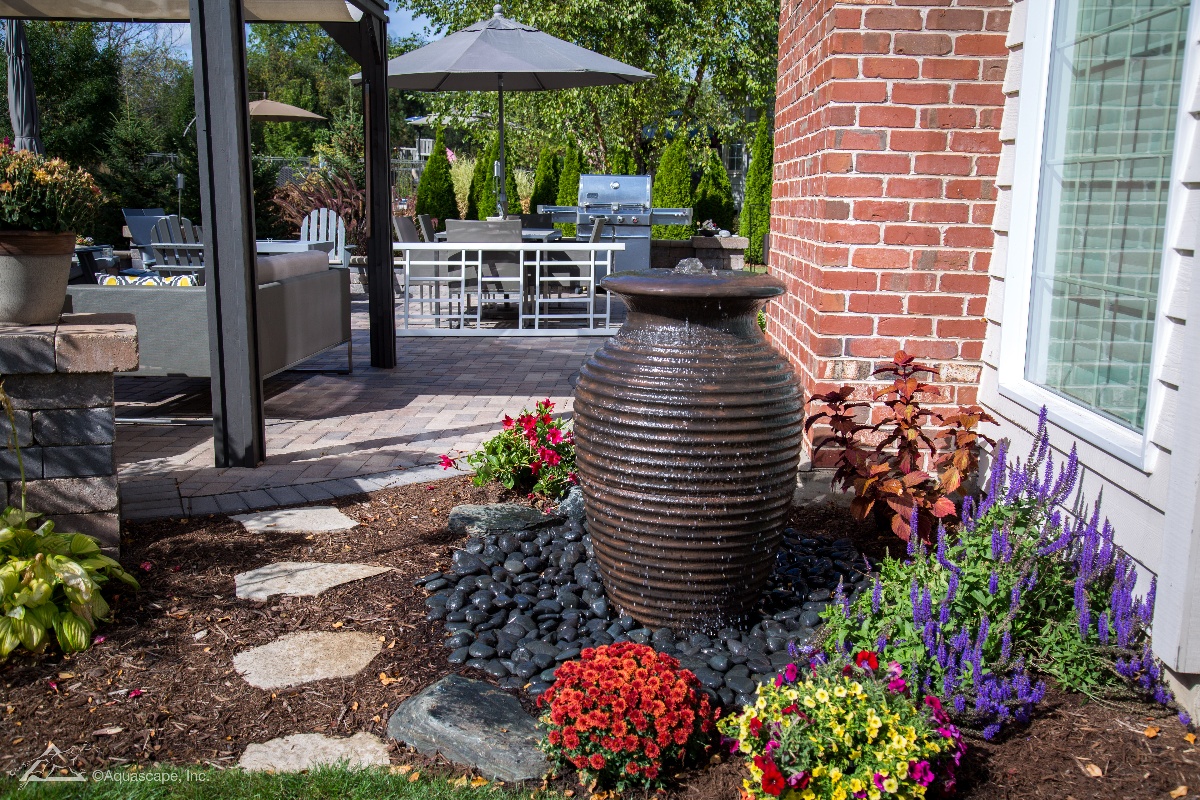 Rippled Urn water feature with plantings and stone