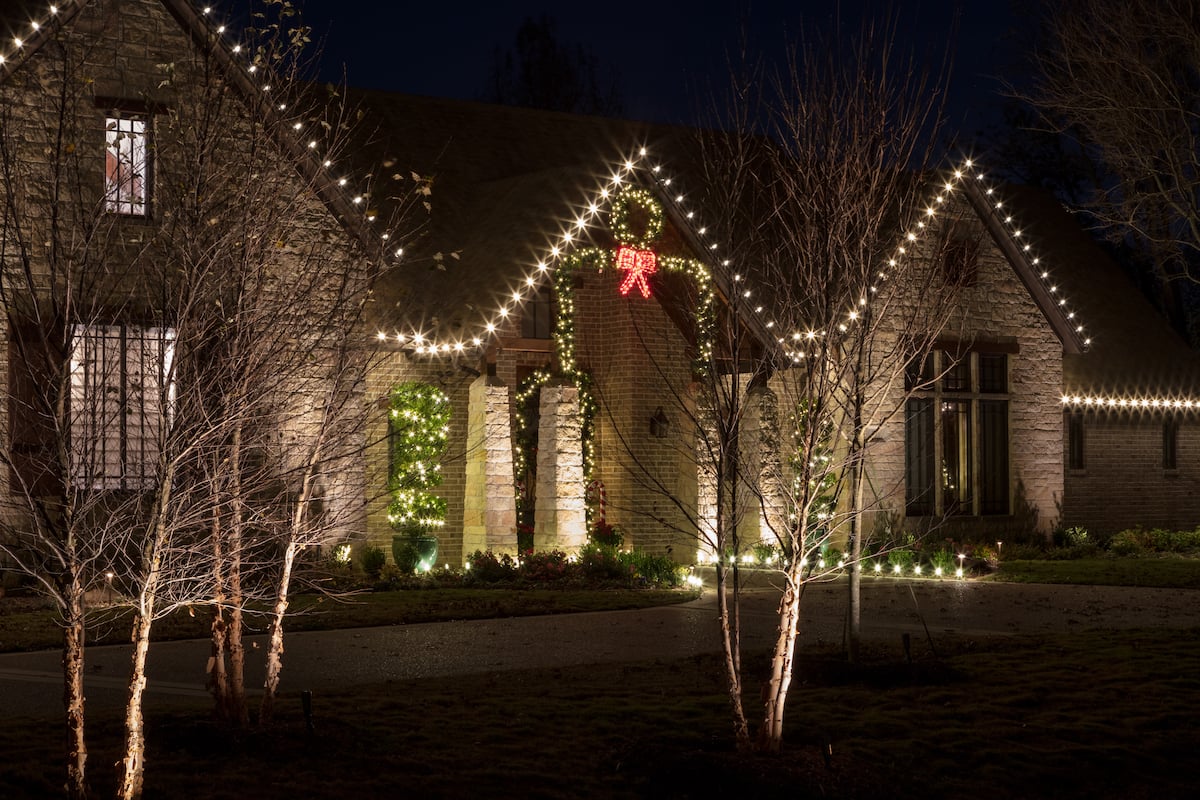 holiday lighting with wreath over front door