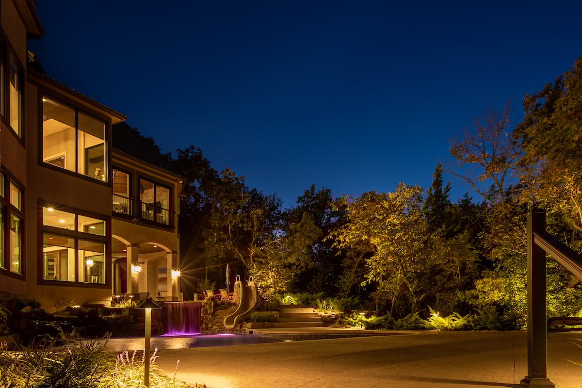 pool and patio with landscape lighting