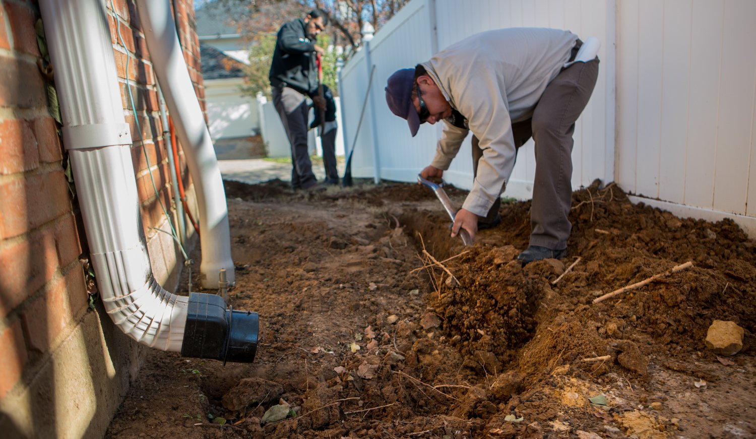 grassperson-crew-drainage-shovel-fence-4