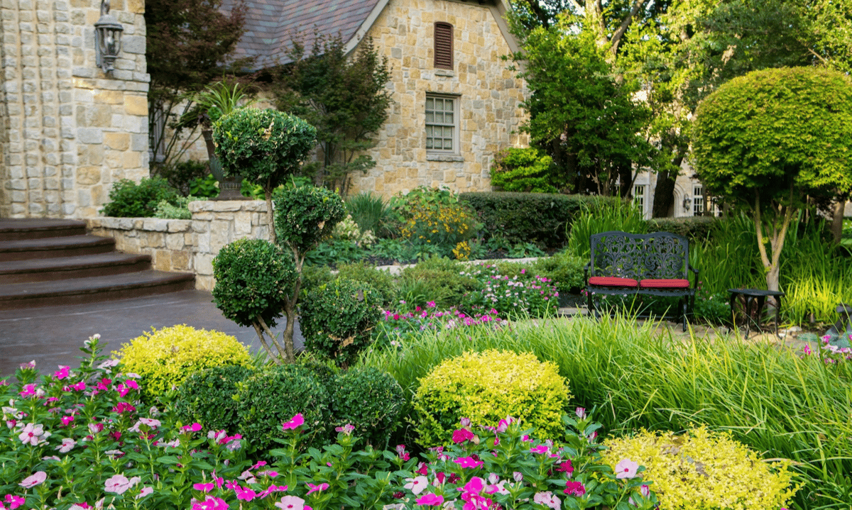 shrubs grasses and flowers around entrance of home