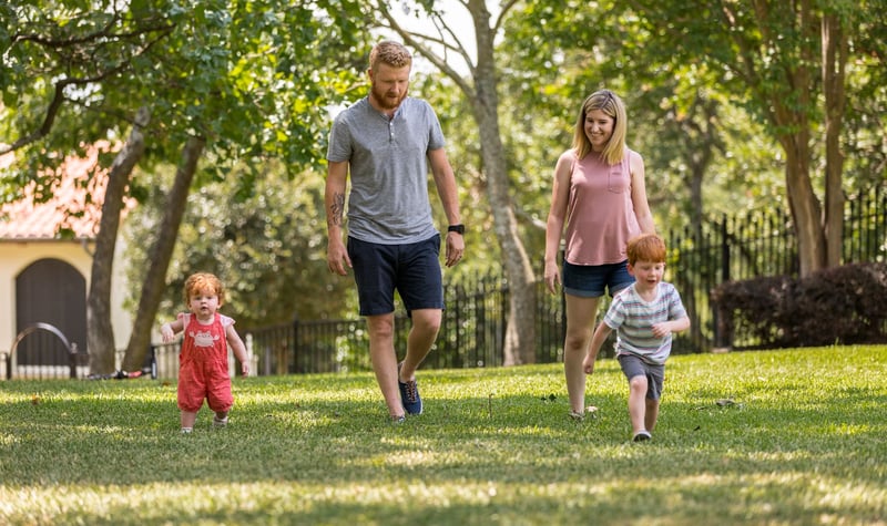 family in healthy lawn with lawn care services