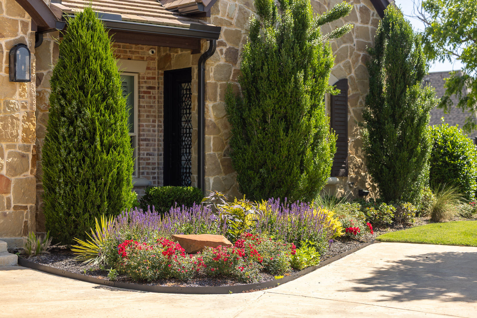 colorful landscape bed front of house