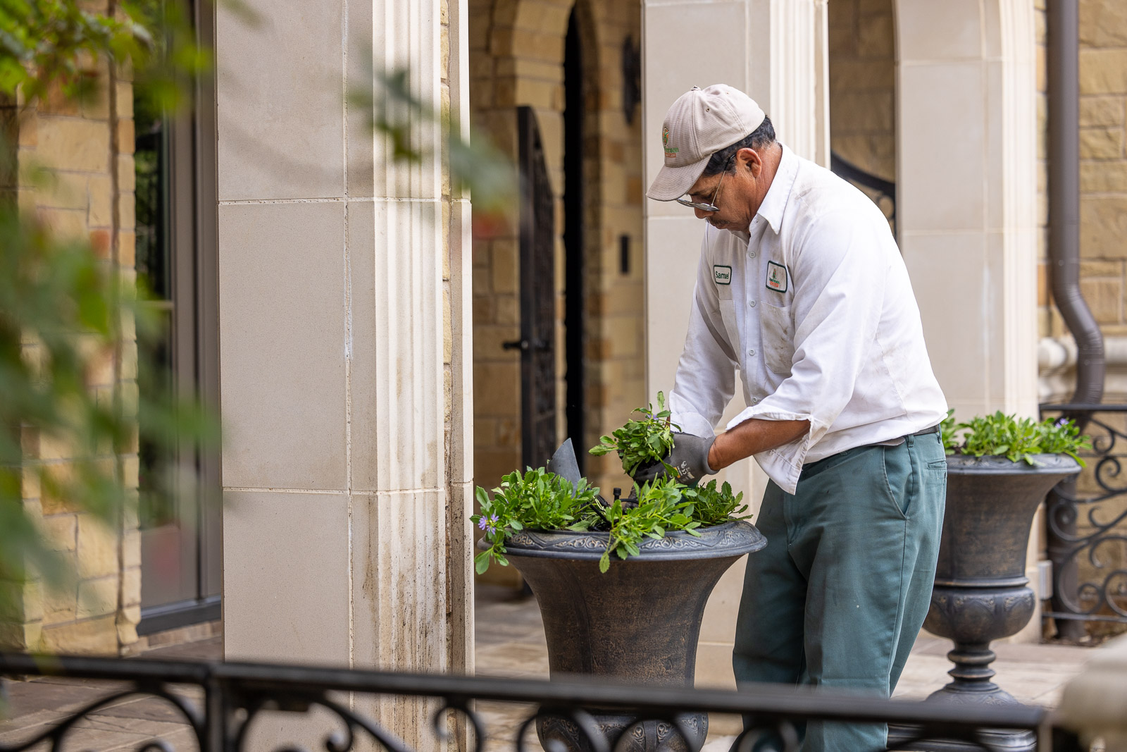 crew planting annuals container gardens front entrance 