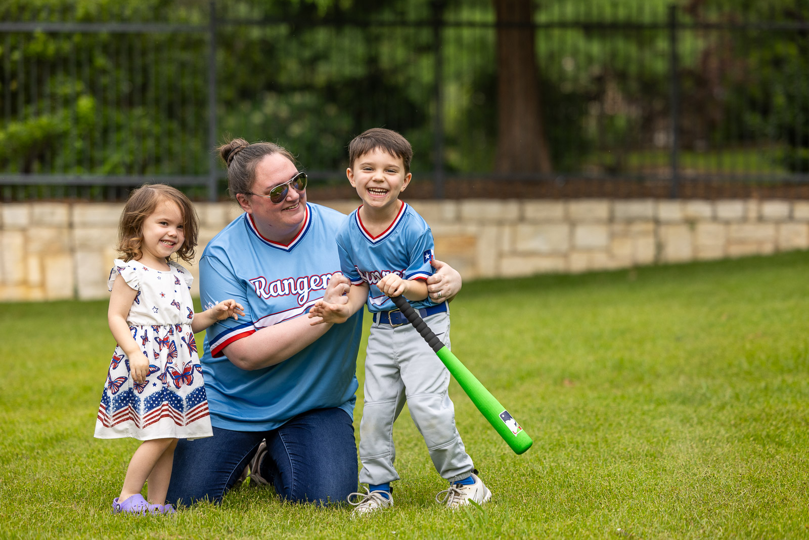 family smiling on green lawn 1