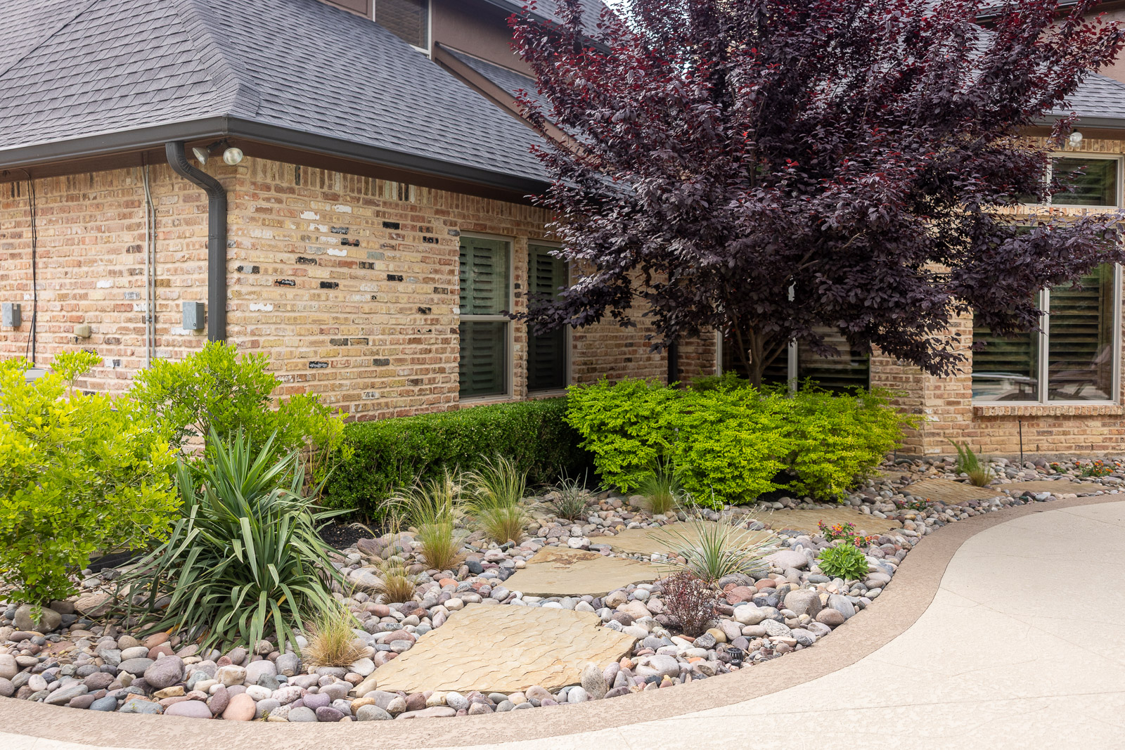 large flagstone walkway in landscape beds 