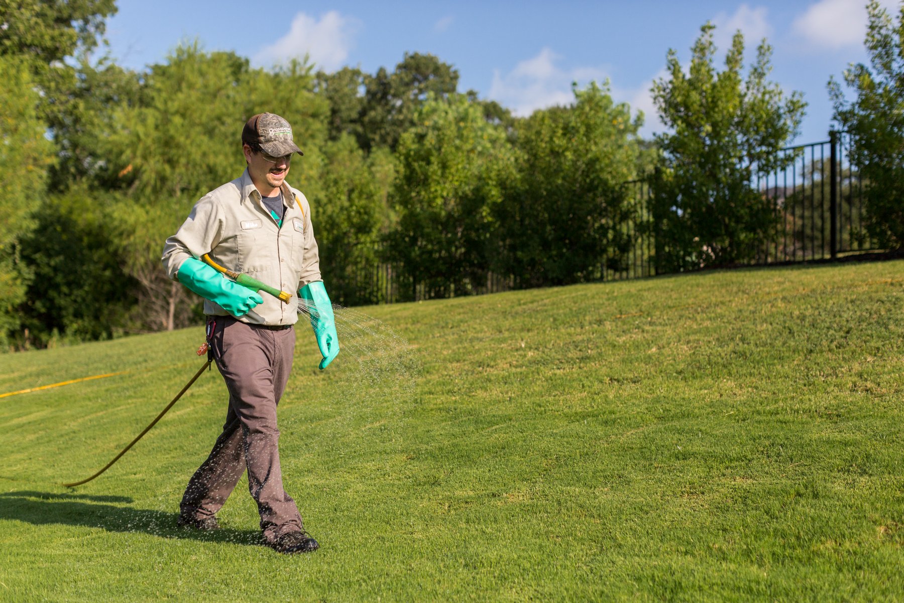 lawn care technician spraying 6-1